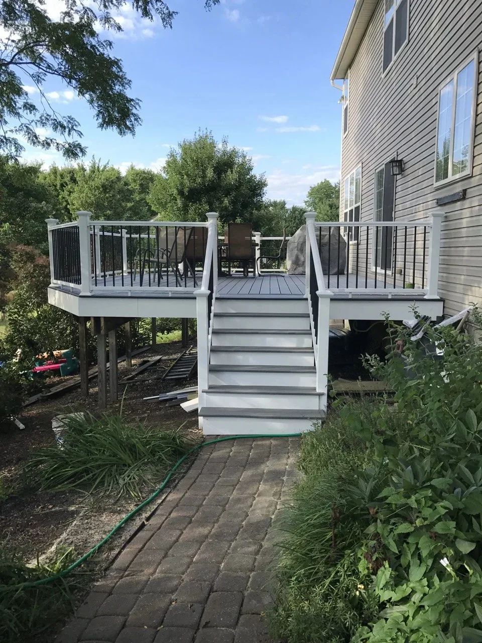 Large composite deck with white posts and black balusters