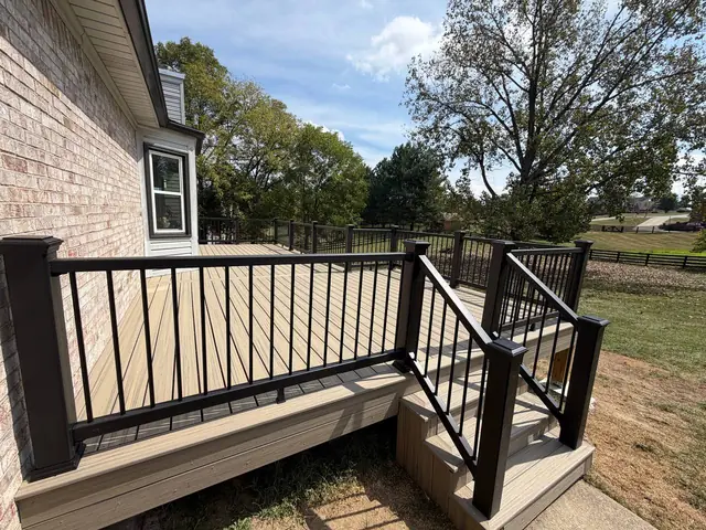 Completed Trex composite deck and Charcoal Black stair railings beside the Crestwood home Completed Trex composite deck and Charcoal Black stair railings beside the Crestwood home