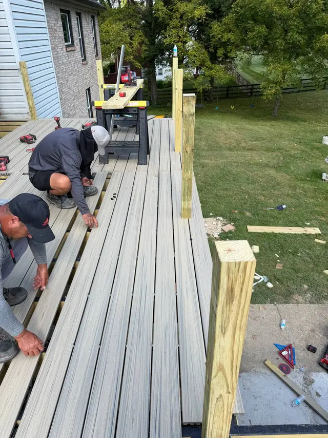 Javi’s Decks crew fitting Trex composite deck boards between the prepared railing posts Javi’s Decks crew fitting Trex composite deck boards between the prepared railing posts