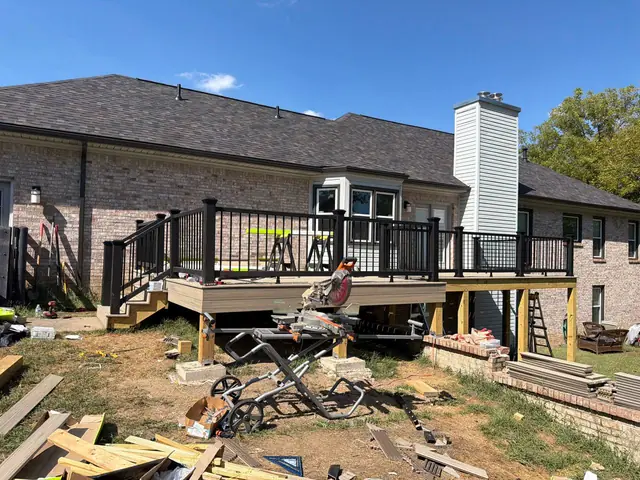 Nearly finished deck with completed railings, unfinished fascia sections and a miter saw on site Nearly finished deck with completed railings, unfinished fascia sections and a miter saw on site