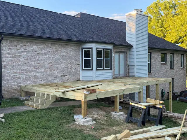Wide front view of the new deck framing and stair stringers before composite decking Wide front view of the new deck framing and stair stringers before composite decking