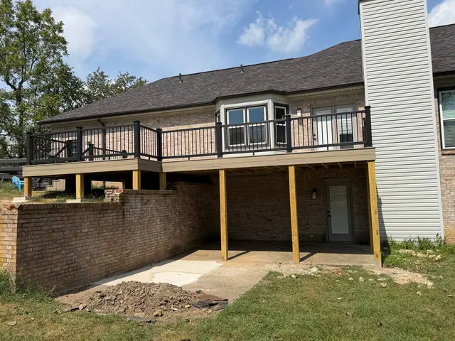 Wide view of the finished composite deck with matching fascia and black railings Wide view of the finished composite deck with matching fascia and black railings