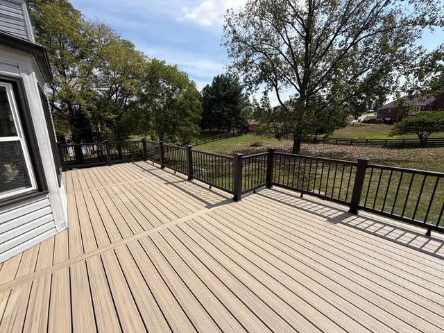 Honey Grove composite decking with divider boards and a picture frame border overlooking the backyard Honey Grove composite decking with divider boards and a picture frame border overlooking the backyard