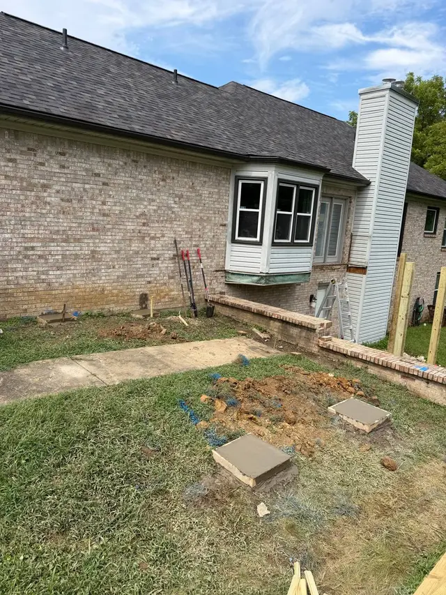 Fresh concrete footing tops in the cleared area where the old deck stood Fresh concrete footing tops in the cleared area where the old deck stood