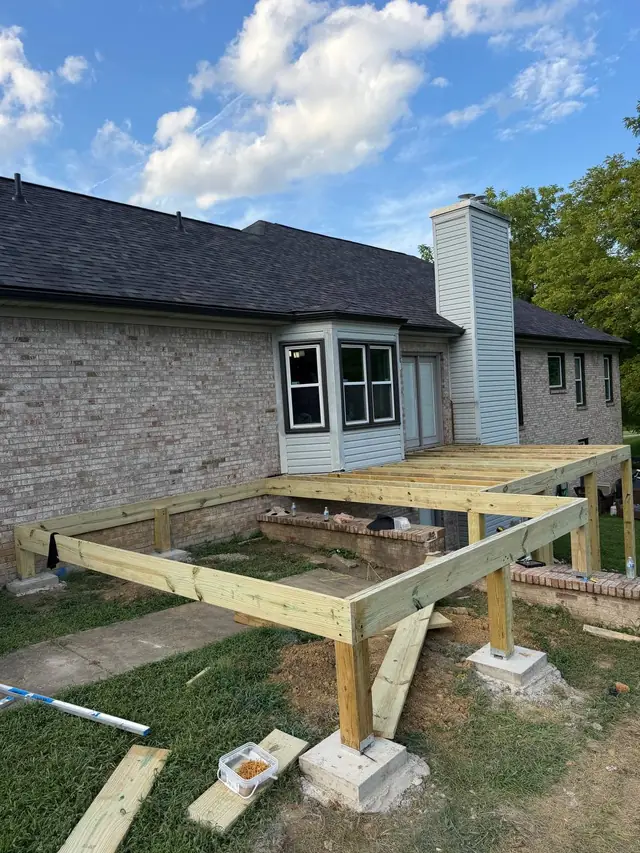 New perimeter framing on support posts with joists installed across part of the deck New perimeter framing on support posts with joists installed across part of the deck