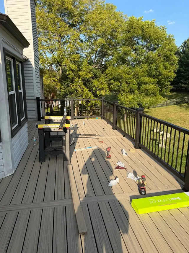 Trex Charcoal Black railings being assembled with tools and railing components on the new decking Trex Charcoal Black railings being assembled with tools and railing components on the new decking
