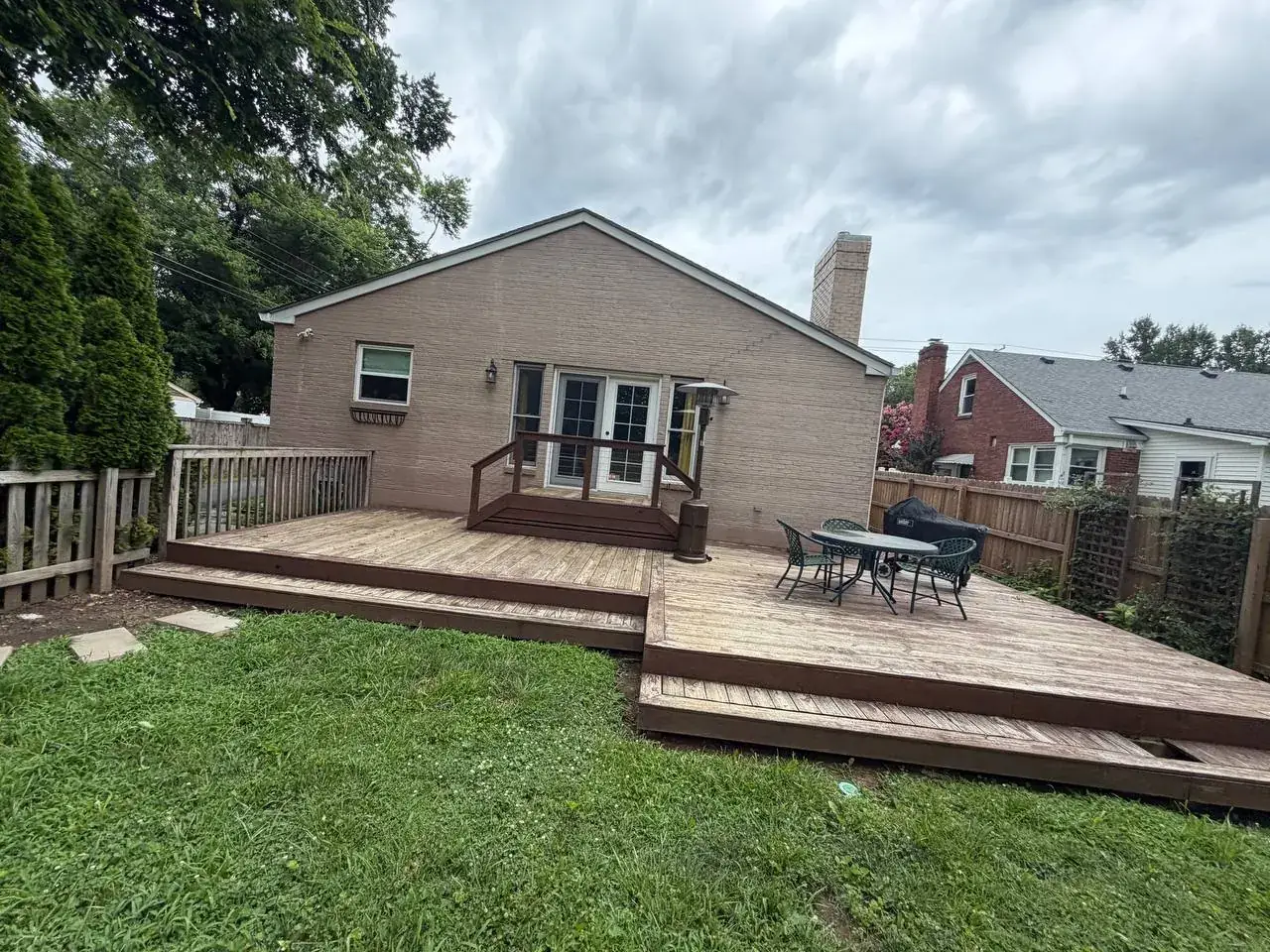 Aging multi-level wood deck with visibly weathered decking