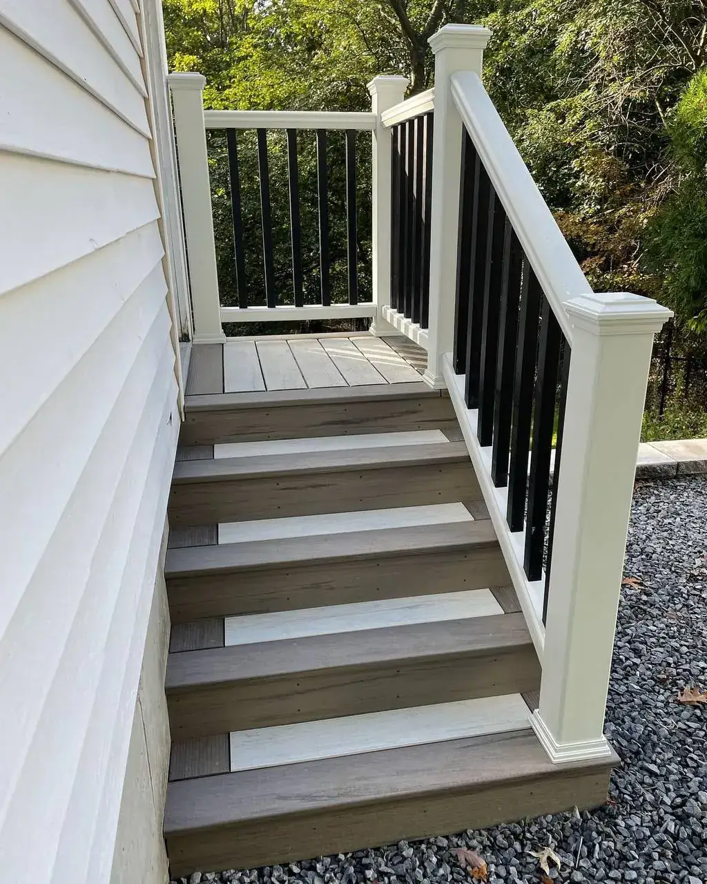 Composite deck stairs with white posts and black balusters