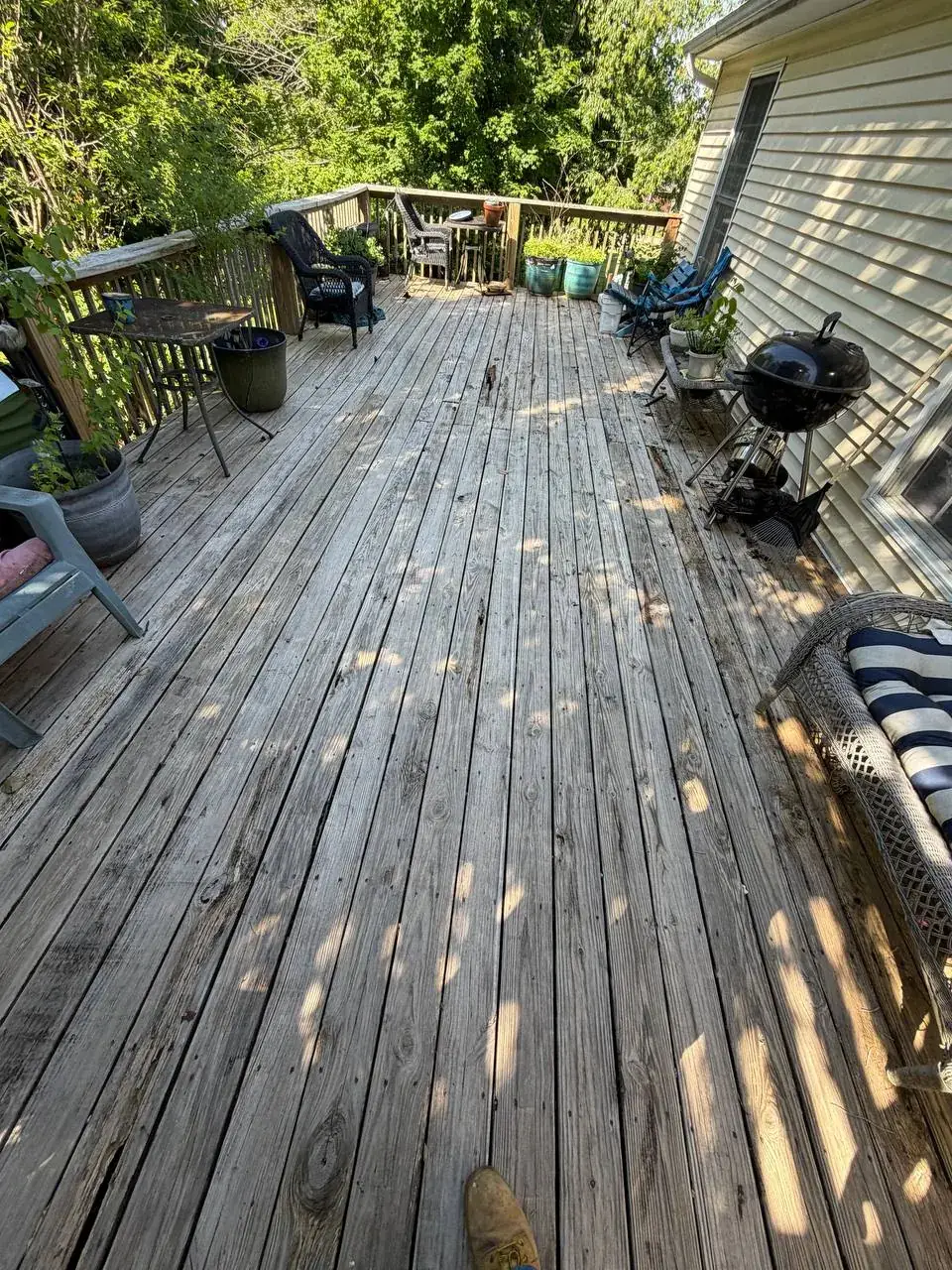 Heavily weathered wood deck boards before resurfacing