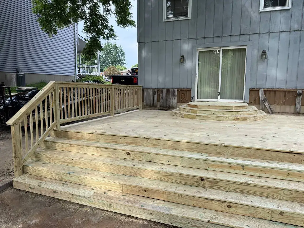 Completed pressure-treated deck with wide wraparound steps