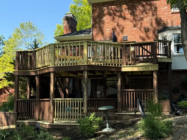 Restored three-level deck beside a brick home in Prospect, with new pressure treated railings and retained brown structural elements