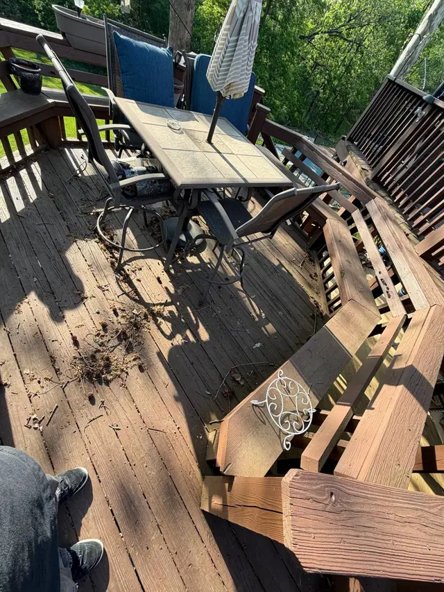 Worn middle-level deck boards and built-in bench railings around the outdoor dining area