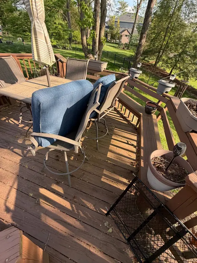 Weathered middle-level decking and built-in bench seating around a patio table before the Prospect restoration