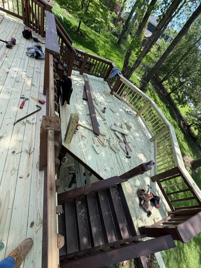 View from the upper deck of new middle-level boards, partly rebuilt railings, tools and wood offcuts