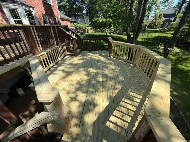Restored middle platform with new wood decking and railings beside the stairs to the upper deck in Prospect